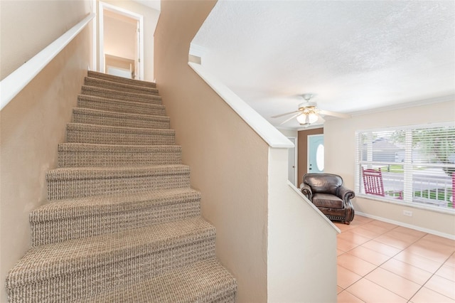 5607 Tanagergrove Way, Lithia, FL 33547 - staircase with a ceiling fan, tile patterned floors, ornamental molding, and a textured ceiling