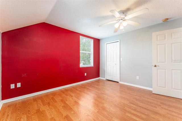 5607 Tanagergrove Way, Lithia, FL 33547 - unfurnished bedroom featuring ceiling fan, vaulted ceiling, baseboards, a closet, and light wood finished floors