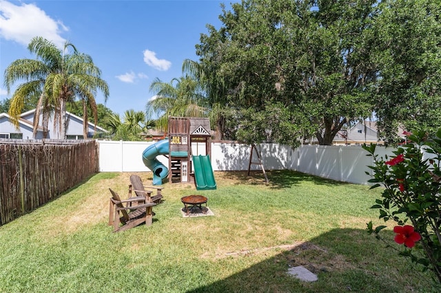 5607 Tanagergrove Way, Lithia, FL 33547 - view of yard featuring a playground, a fenced backyard, and an outdoor fire pit
