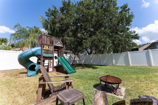 5607 Tanagergrove Way, Lithia, FL 33547 - view of jungle gym featuring a fenced backyard, an outdoor fire pit, and a yard