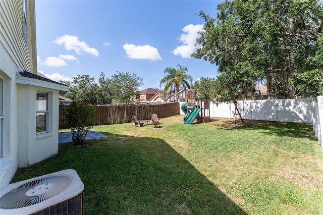 5607 Tanagergrove Way, Lithia, FL 33547 - view of yard with a patio area, central AC unit, a playground, and a fenced backyard