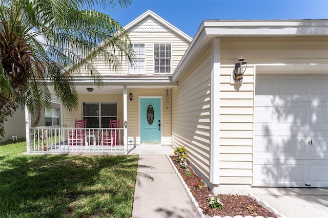 5607 Tanagergrove Way, Lithia, FL 33547 - view of exterior entry featuring a porch and an attached garage