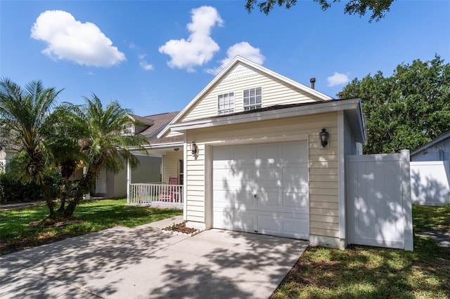 5607 Tanagergrove Way, Lithia, FL 33547 - view of front of property with covered porch, fence, concrete driveway, and a garage
