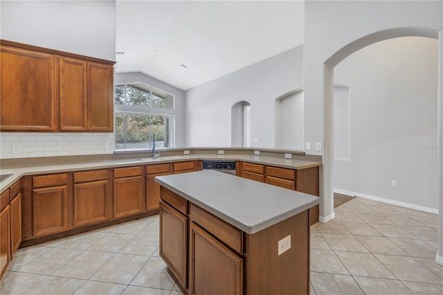 10506 Sky Flower Ct, Land O Lakes, FL 34638 - kitchen with brown cabinetry, stainless steel dishwasher, vaulted ceiling, light tile patterned floors, and a sink