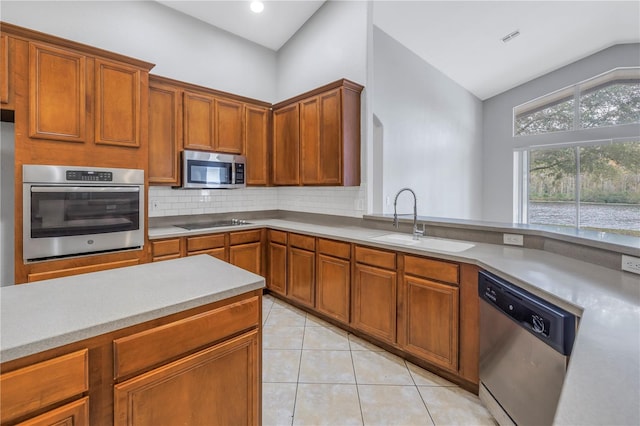 10506 Sky Flower Ct, Land O Lakes, FL 34638 - kitchen featuring appliances with stainless steel finishes, a sink, light countertops, decorative backsplash, and light tile patterned floors