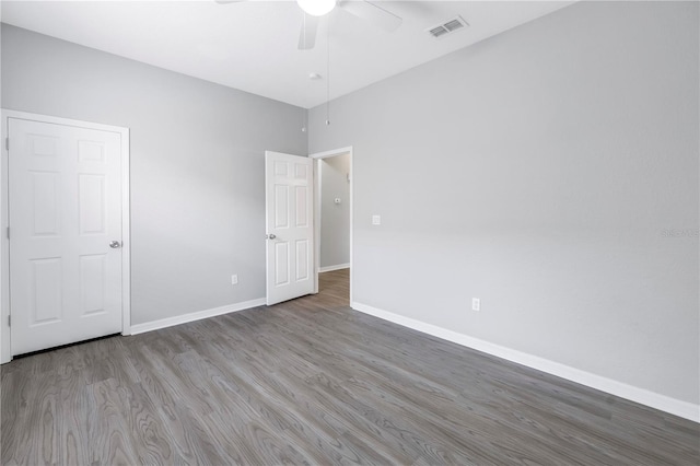 10506 Sky Flower Ct, Land O Lakes, FL 34638 - unfurnished bedroom with ceiling fan, baseboards, visible vents, and wood finished floors