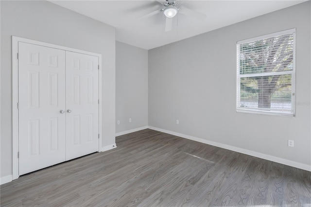 10506 Sky Flower Ct, Land O Lakes, FL 34638 - unfurnished bedroom with a ceiling fan, baseboards, wood finished floors, and a closet