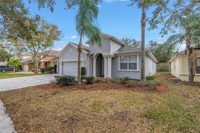 10506 Sky Flower Ct, Land O Lakes, FL 34638 - view of front of house featuring a garage, stucco siding, and driveway