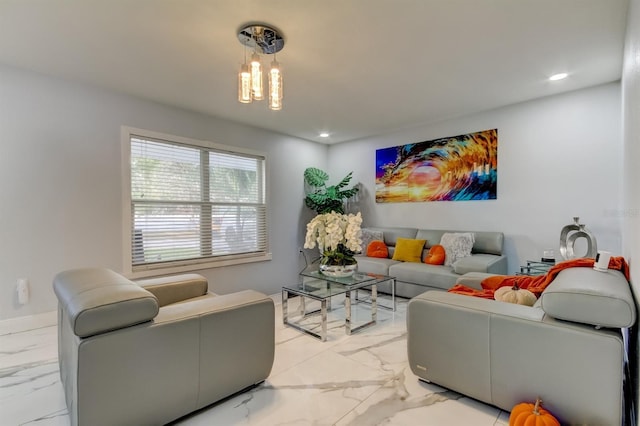 living room featuring recessed lighting, marble finish floor, baseboards, and an inviting chandelier