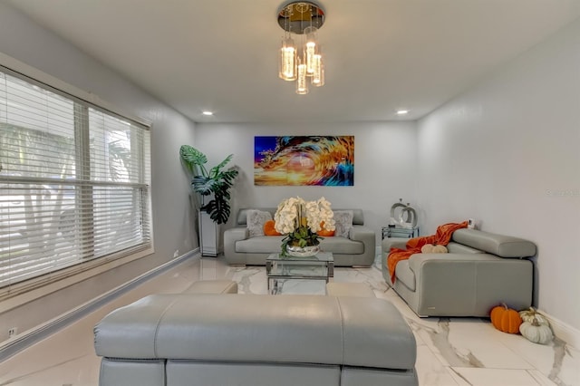 living area featuring baseboards, a notable chandelier, recessed lighting, and marble finish floor