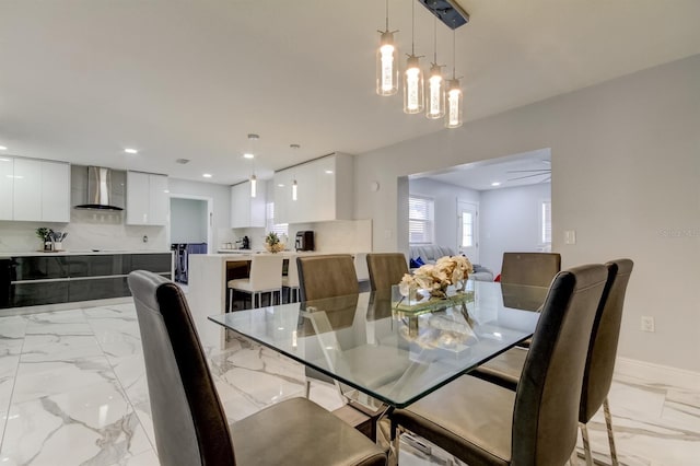 dining space with recessed lighting, baseboards, and marble finish floor