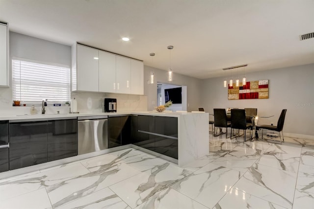 kitchen featuring visible vents, modern cabinets, light countertops, a sink, and dishwasher
