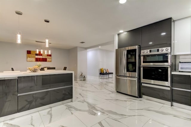 kitchen with pendant lighting, appliances with stainless steel finishes, modern cabinets, light countertops, and recessed lighting