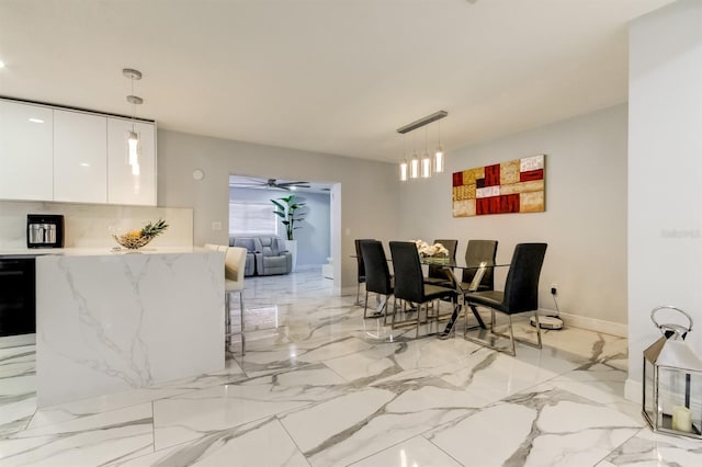 dining space with baseboards and marble finish floor
