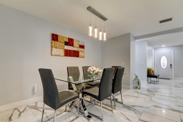 dining area featuring visible vents, marble finish floor, and baseboards
