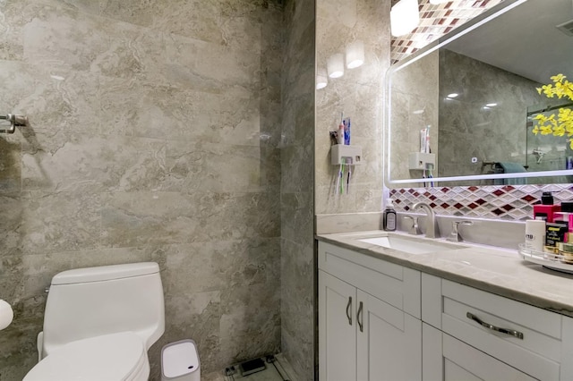 bathroom featuring vanity, decorative backsplash, visible vents, toilet, and tile walls