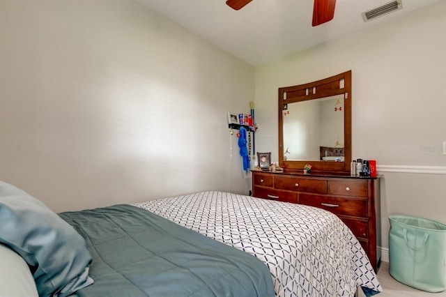 bedroom with light carpet, a ceiling fan, and visible vents