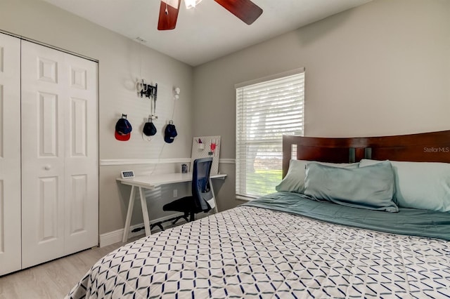bedroom with a closet, ceiling fan, and light wood-style floors