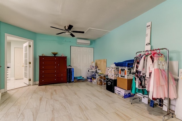 interior space with an AC wall unit, ceiling fan, and a closet