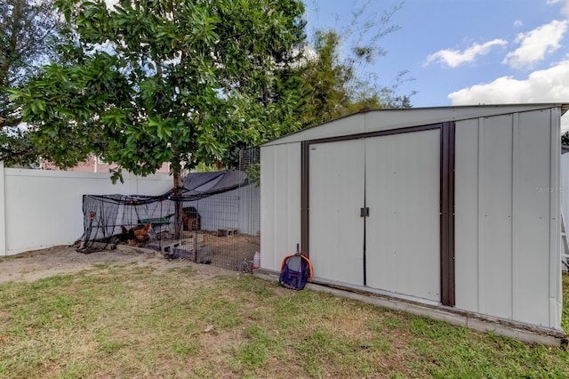 view of shed featuring fence