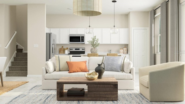 living room with stairway, baseboards, and a towering ceiling