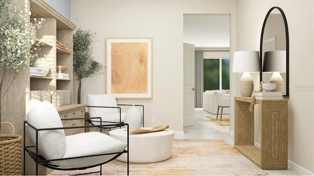 sitting room with baseboards and tile patterned floors