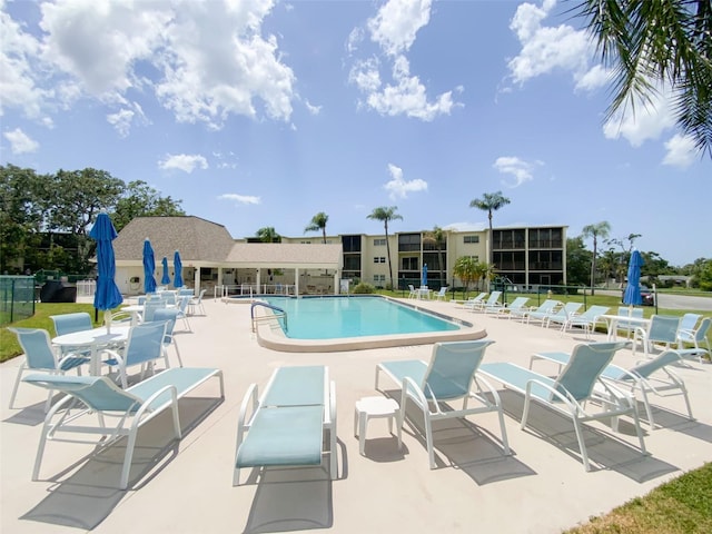 community pool featuring a patio and fence
