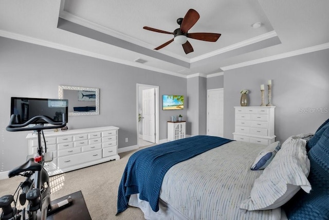 carpeted bedroom featuring a raised ceiling, ornamental molding, baseboards, and ceiling fan