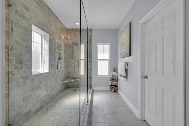 bathroom with marble look tiles, baseboards, a stall shower, healthy amount of natural light, and recessed lighting