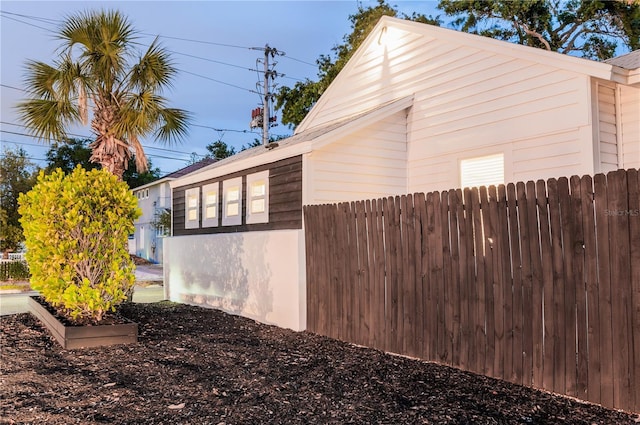 view of property exterior featuring fence