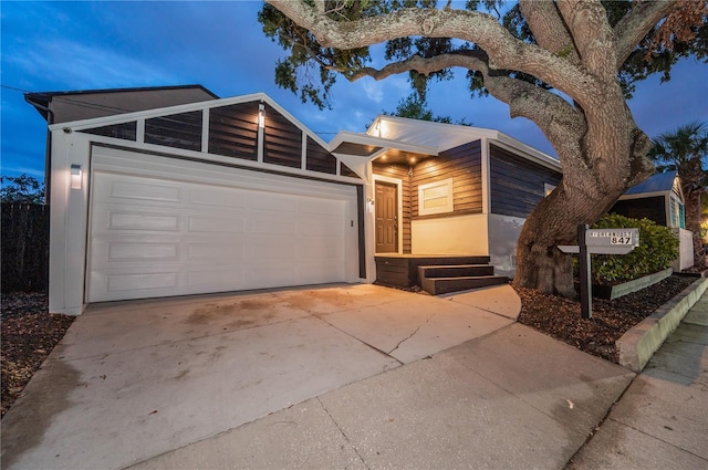 view of front of property featuring a garage and concrete driveway