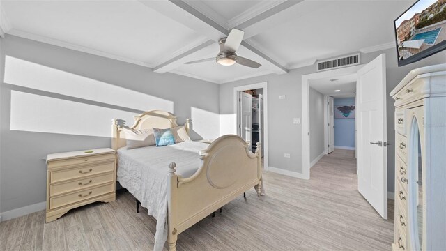 bedroom with baseboards, beamed ceiling, light wood-type flooring, and visible vents