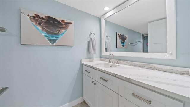 bathroom featuring baseboards and vanity