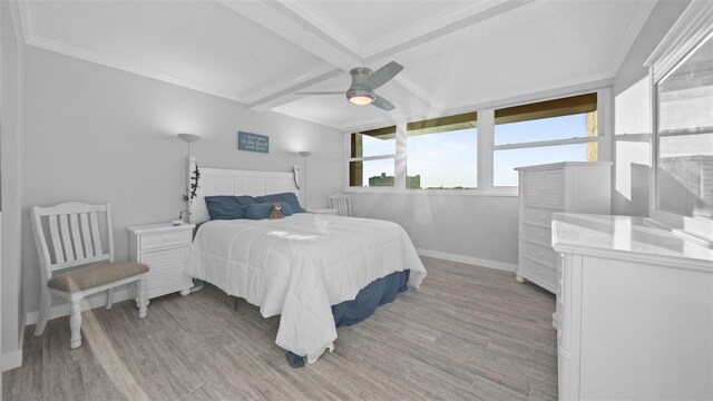 bedroom featuring baseboards, light wood finished floors, beam ceiling, and coffered ceiling