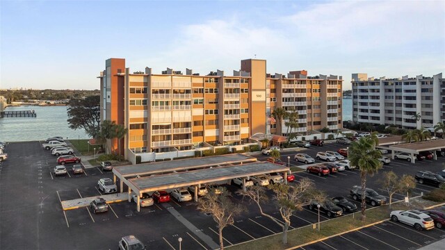 view of property with a water view and uncovered parking