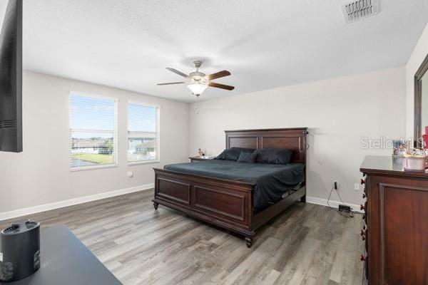 11760 Winterset Cove Dr, Riverview, FL 33579 - bedroom featuring visible vents, baseboards, ceiling fan, and wood finished floors