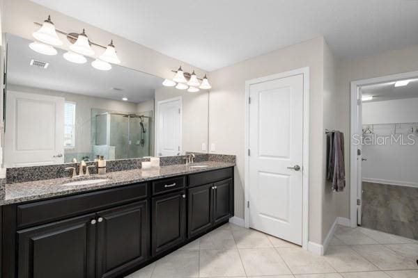 11760 Winterset Cove Dr, Riverview, FL 33579 - full bathroom featuring visible vents, a sink, double vanity, and a shower stall