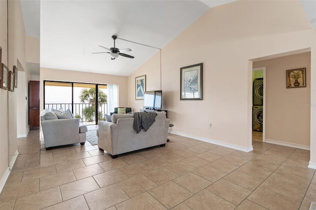 7540 Sunshine Skyway Ln S # 219, Saint Petersburg, FL 33711 - living area with stacked washing maching and dryer, high vaulted ceiling, baseboards, and a ceiling fan