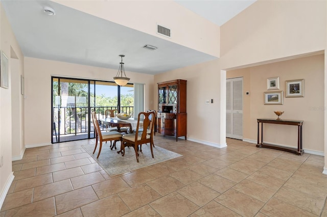 7540 Sunshine Skyway Ln S # 219, Saint Petersburg, FL 33711 - dining area featuring visible vents, baseboards, and a towering ceiling
