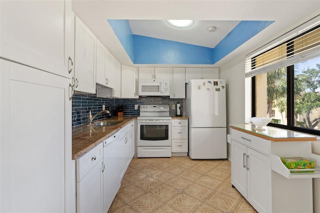 7540 Sunshine Skyway Ln S # 219, Saint Petersburg, FL 33711 - kitchen with white appliances, white cabinets, a sink, and tasteful backsplash