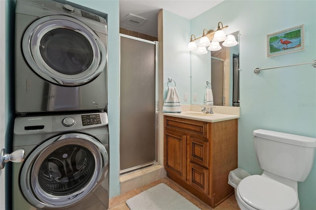 7540 Sunshine Skyway Ln S # 219, Saint Petersburg, FL 33711 - full bathroom featuring vanity, tile patterned flooring, stacked washer / dryer, toilet, and a stall shower