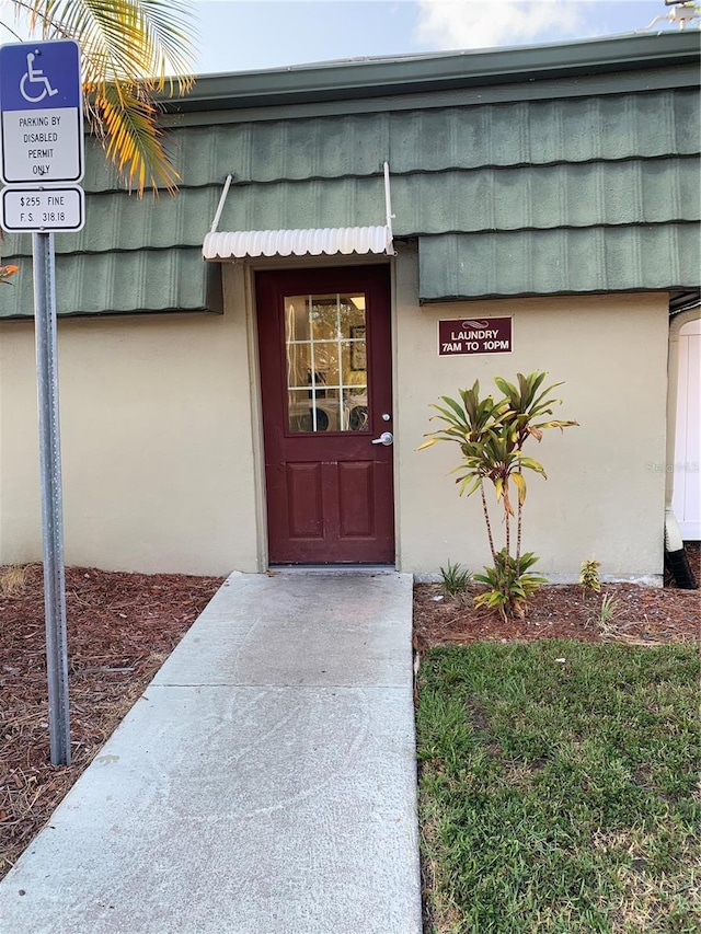 1799 N Highland Ave Unit 170, Clearwater, FL 33755 - doorway to property with stucco siding and mansard roof