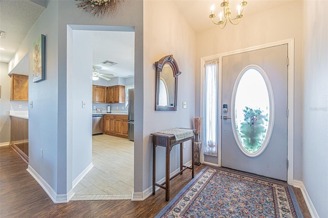 11311 Corey Pavin Ln, San Antonio, FL 33576 - entrance foyer with light wood-type flooring, a chandelier, and ceiling fan