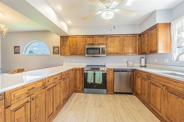 11311 Corey Pavin Ln, San Antonio, FL 33576 - kitchen featuring stainless steel appliances, brown cabinetry, and light countertops