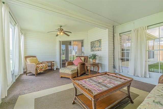 11311 Corey Pavin Ln, San Antonio, FL 33576 - sunroom featuring a ceiling fan, carpet floors, plenty of natural light, and wood walls