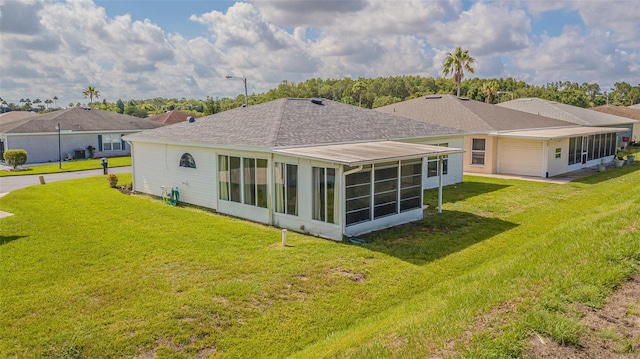 11311 Corey Pavin Ln, San Antonio, FL 33576 - back of property featuring a sunroom, a lawn, a shingled roof, and an attached garage