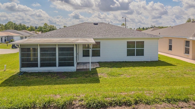 11311 Corey Pavin Ln, San Antonio, FL 33576 - rear view of house featuring a lawn, a sunroom, and a shingled roof