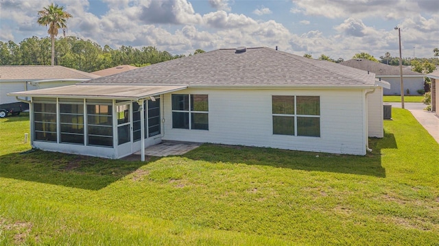 11311 Corey Pavin Ln, San Antonio, FL 33576 - back of house featuring a sunroom, roof with shingles, and a yard