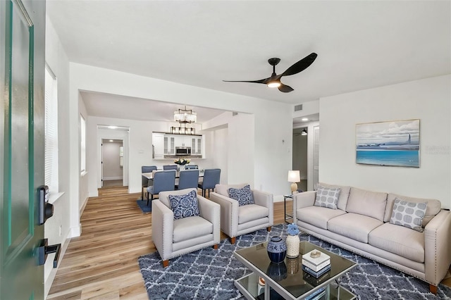 10011 N Annette Ave, Tampa, FL 33612 - living room with light wood-type flooring, a chandelier, and ceiling fan