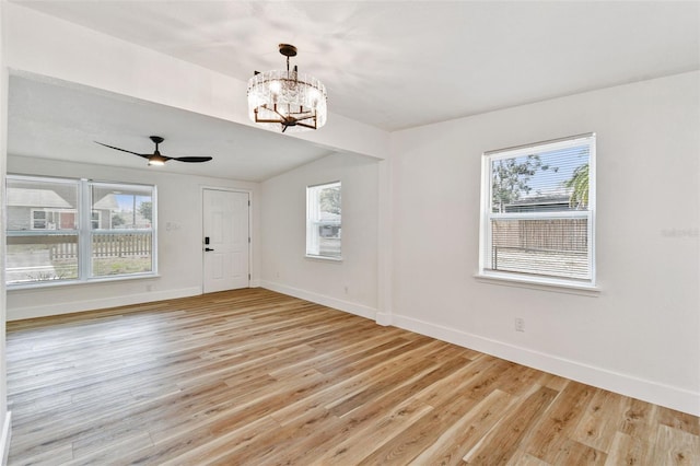 10011 N Annette Ave, Tampa, FL 33612 - foyer entrance featuring healthy amount of natural light, light wood finished floors, and a chandelier